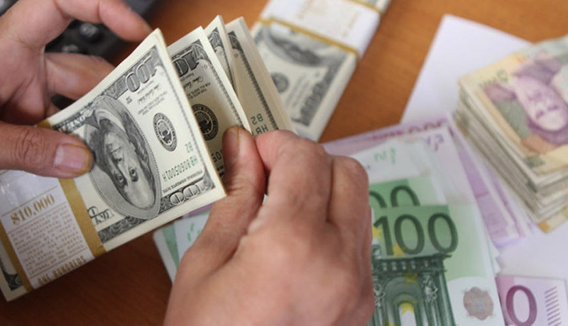 The picture illustrates euro and United States 100-dollar banknotes bearing the portrait of US statesman, inventor and diplomat Benjamin Franklin next to Iran's rial banknotes, bearing a portrait of Iran's late founder of Islamic Republic Ayatollah Ruhollah Khomeini in Tehran on September 30, 2012.  Iran's currency, the rial, dived to a new low of around 29,600 to the dollar in open trading, losing over 60 percent of its value since the end of last year according to exchange tracking websites as draconian Western economic sanctions take effect that has spurred already high inflation to even greater heights, with food costs soaring more than 50 percent. AFP PHOTO/ATTA KENARE        (Photo credit should read ATTA KENARE/AFP/GettyImages)